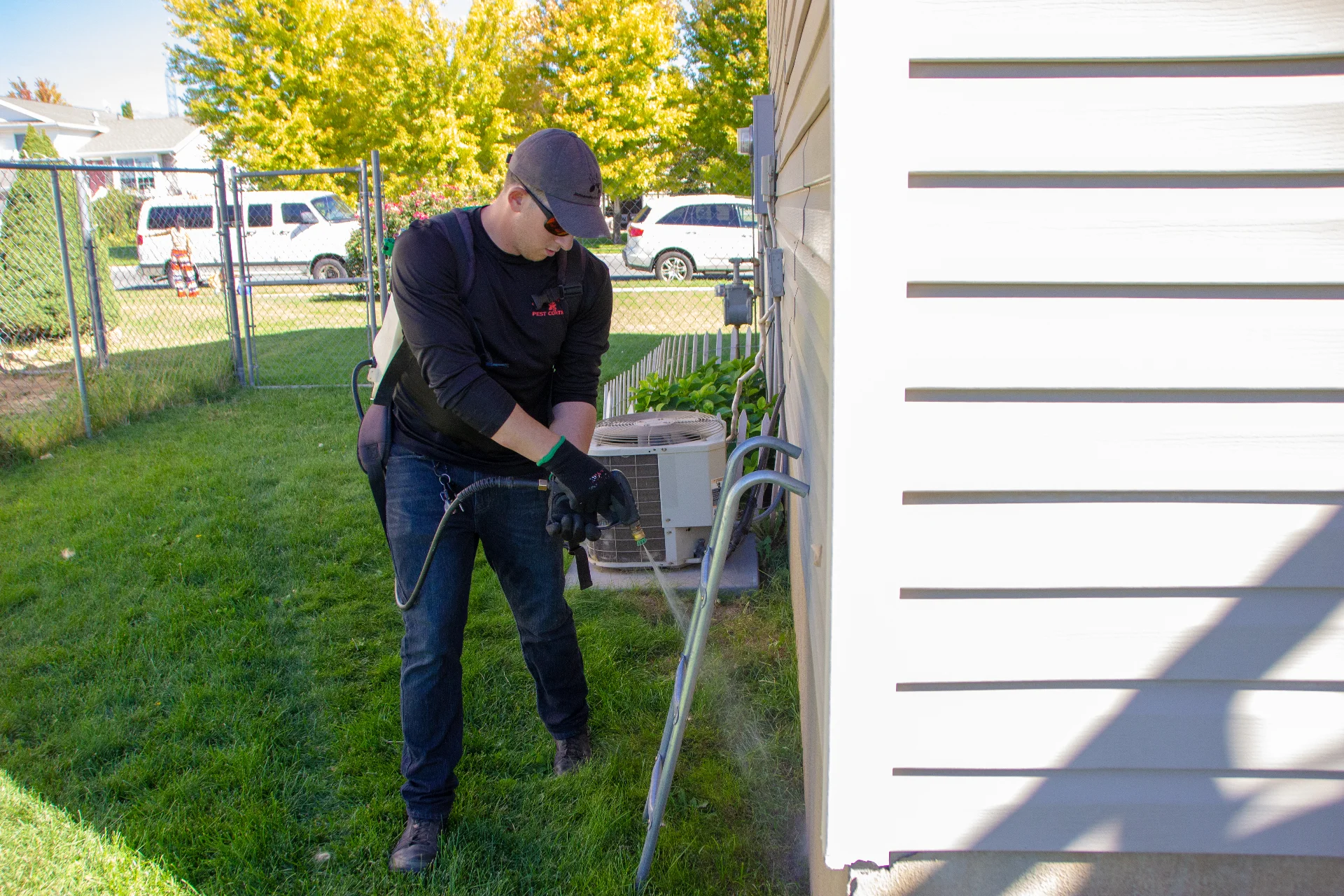 Professional exterminator treating a porch in Lehi near Traverse Mountain